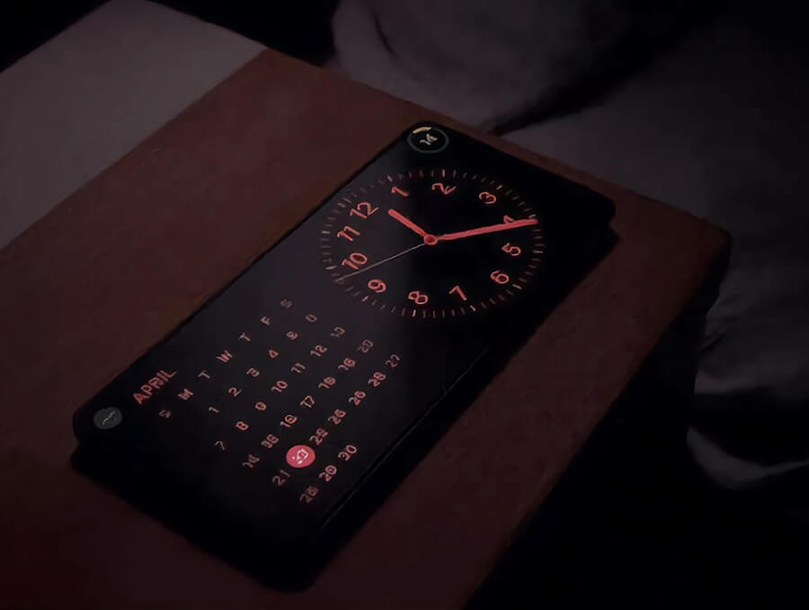 Iphone on table with clock