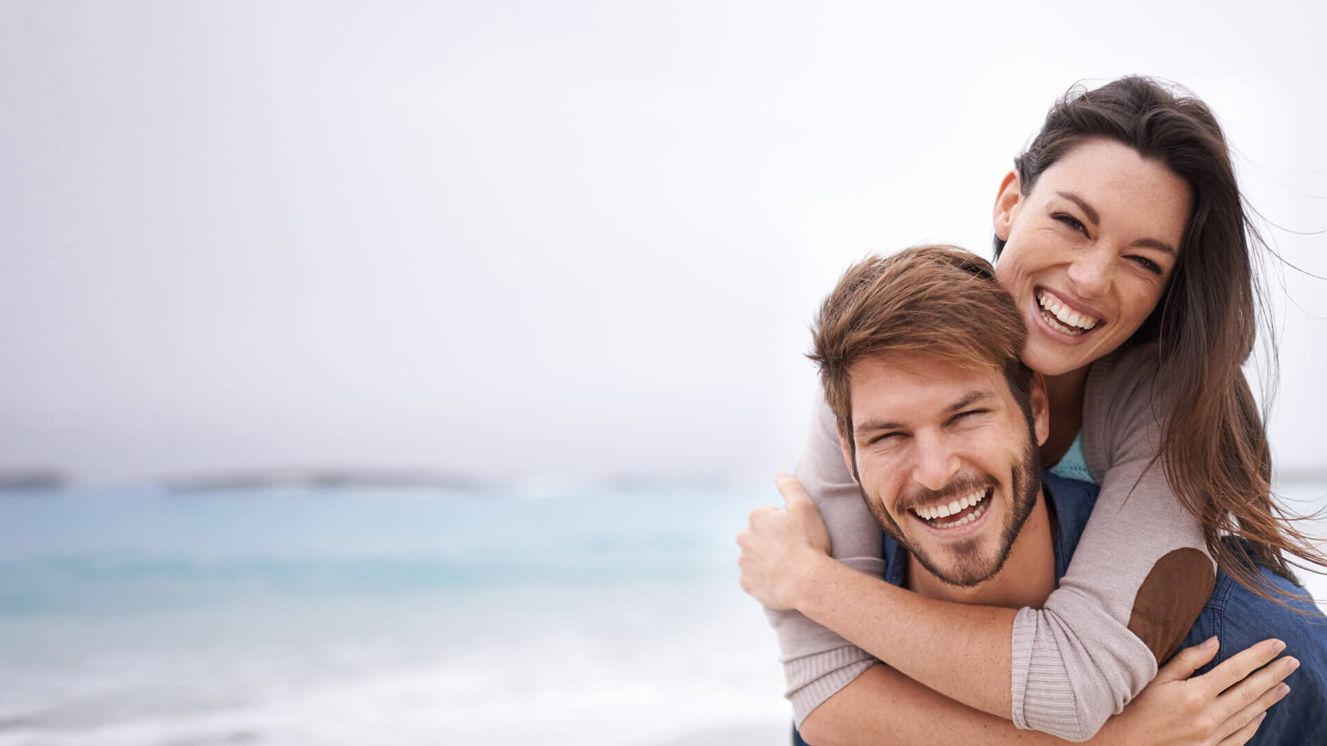 Couple on beach smiling