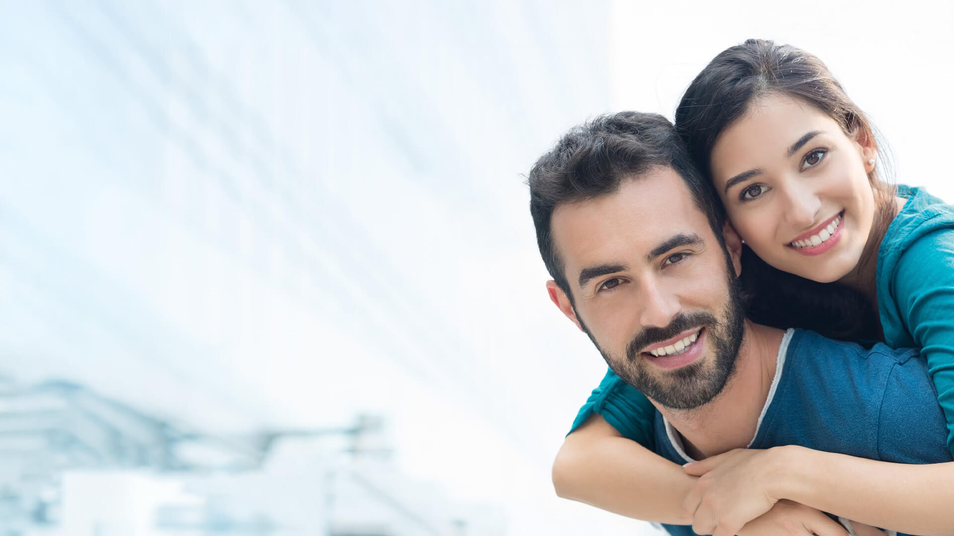 Couple smiling doing a piggy back ride