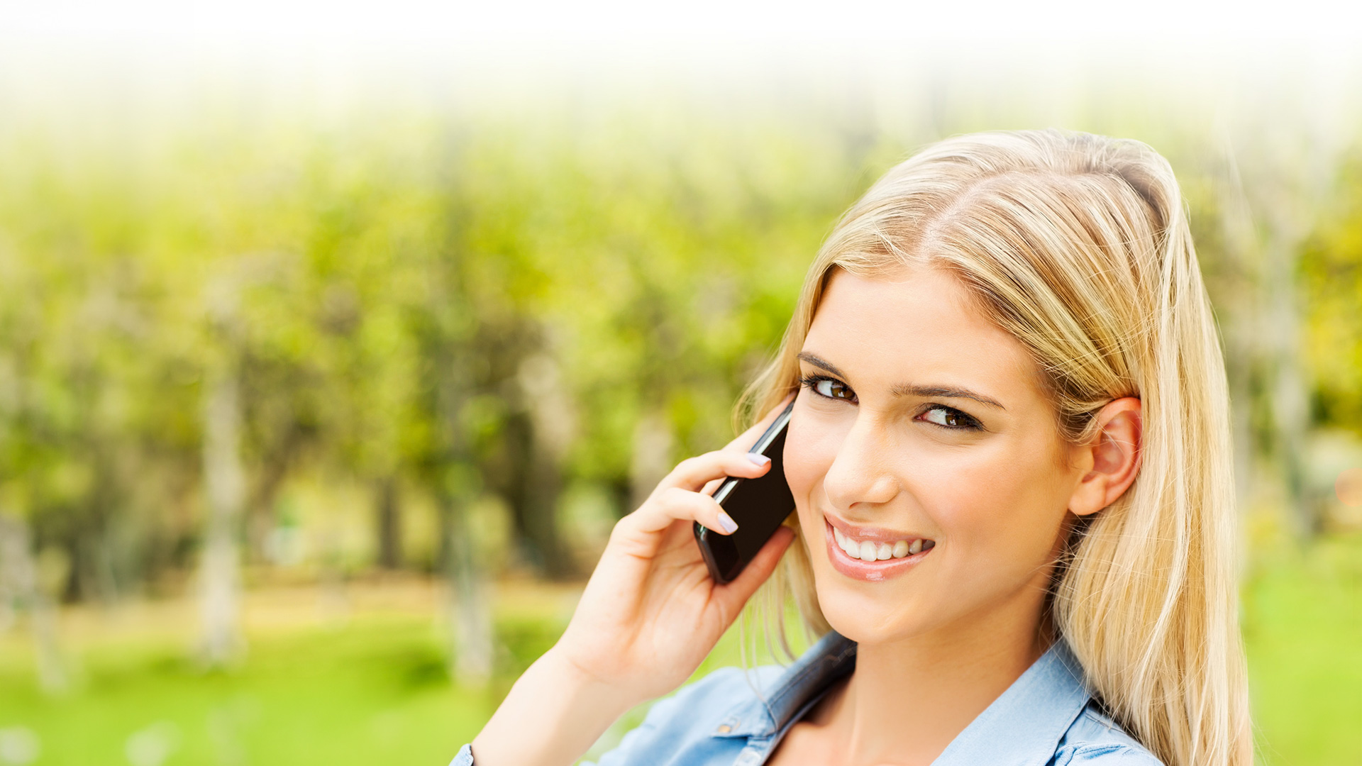 Blonde female smiling on phone