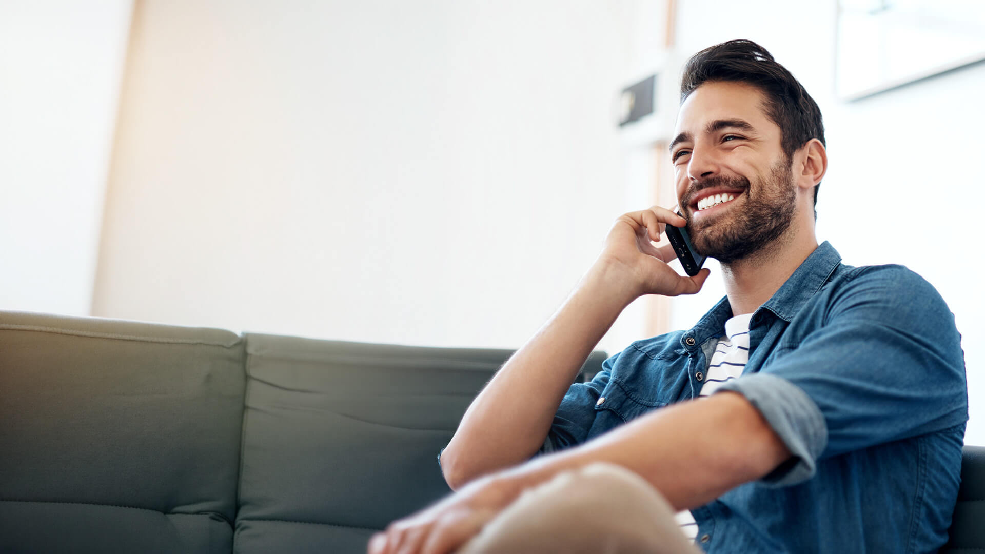 Young man on iphone smiling